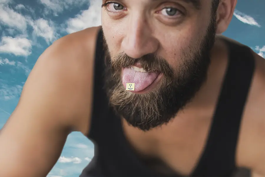 man eating LSD tab