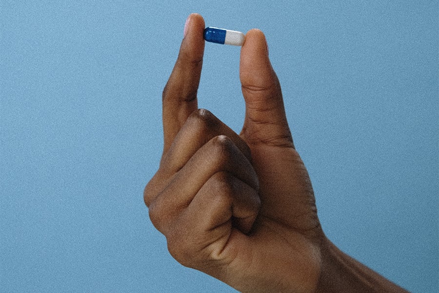 hand holding MDMA capsule
