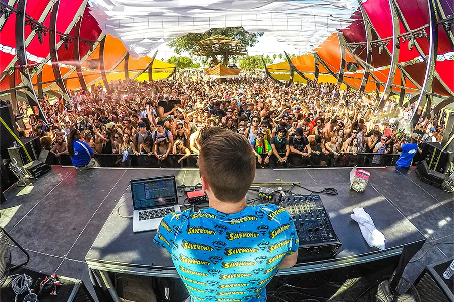 photo of DJ playing in front of crowd at Coachella