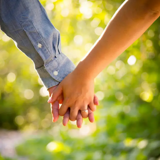 Close up of people holding hands