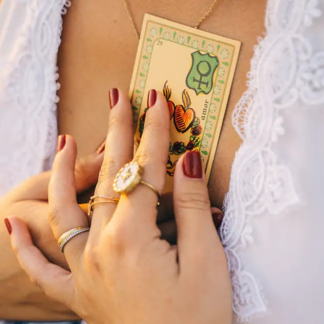Hand Holding Tarot Card over Heart