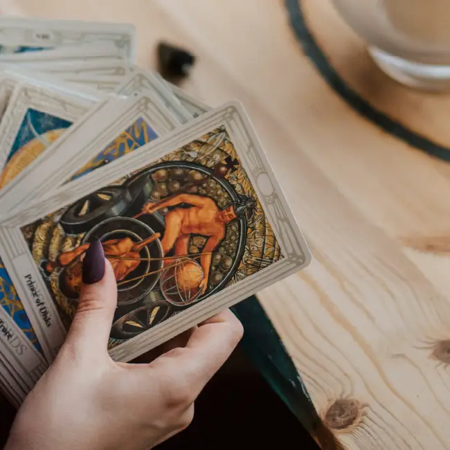 Close up of hands holding tarot card