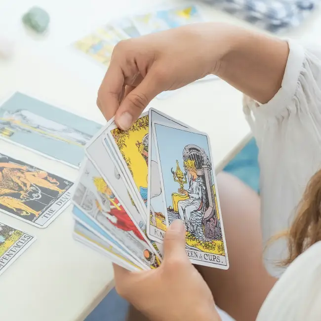 Close up of hands holding tarot cards