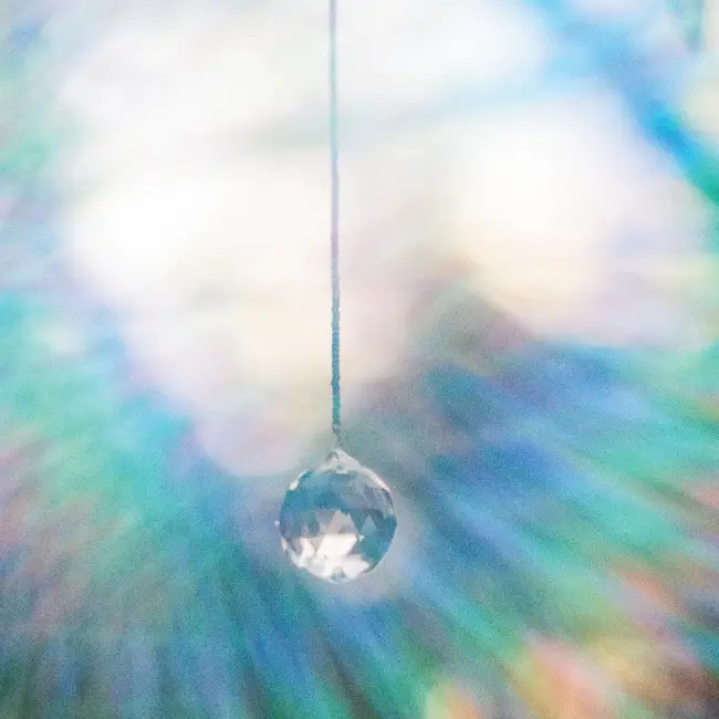 Image of Crystal Ball Hanging with Rainbow Reflection
