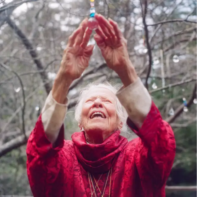 Woman Reaching up toward crystal ball outside