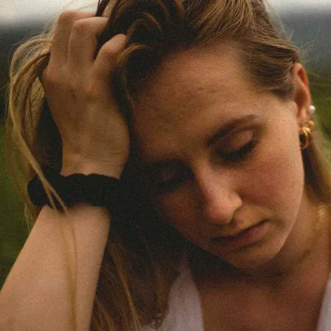 Person Looking Sad with Hand on Head