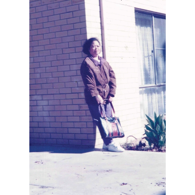 Old Photo of Woman Standing Against Building